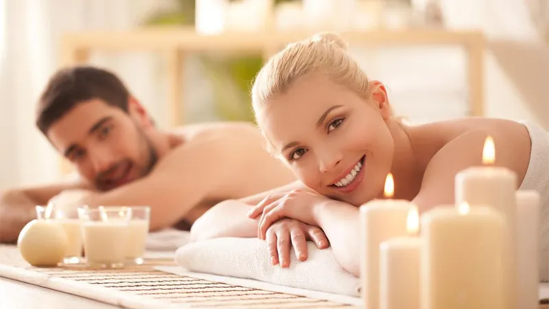 A couple relaxing side by side on treatment tables