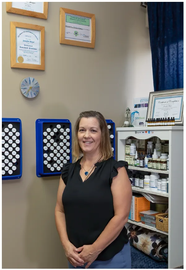 Jennifer Meyer-Kaiser in her office in front of her framed certificates