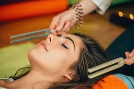 Tuning forks held near a relaxed client's head